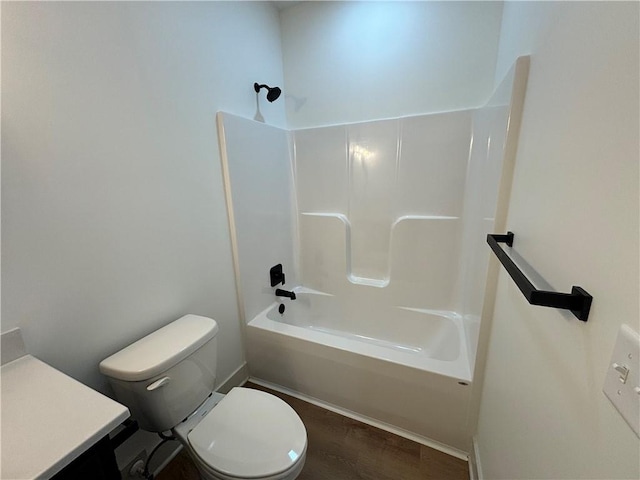 full bathroom with hardwood / wood-style floors, vanity, shower / bath combination, and toilet