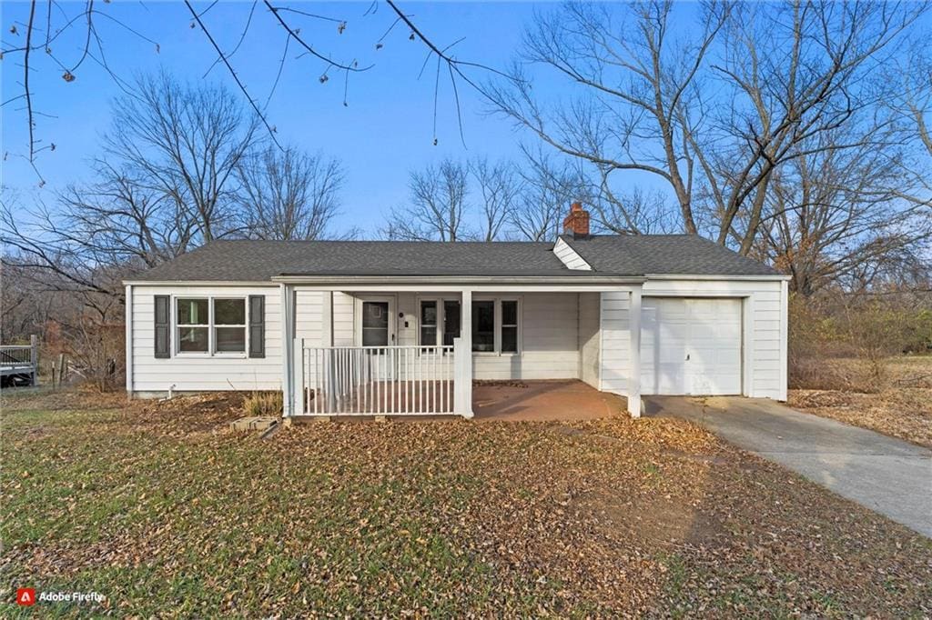 ranch-style home featuring a porch and a garage