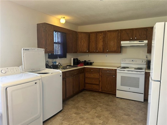 kitchen with washer and dryer, sink, white appliances, and a textured ceiling