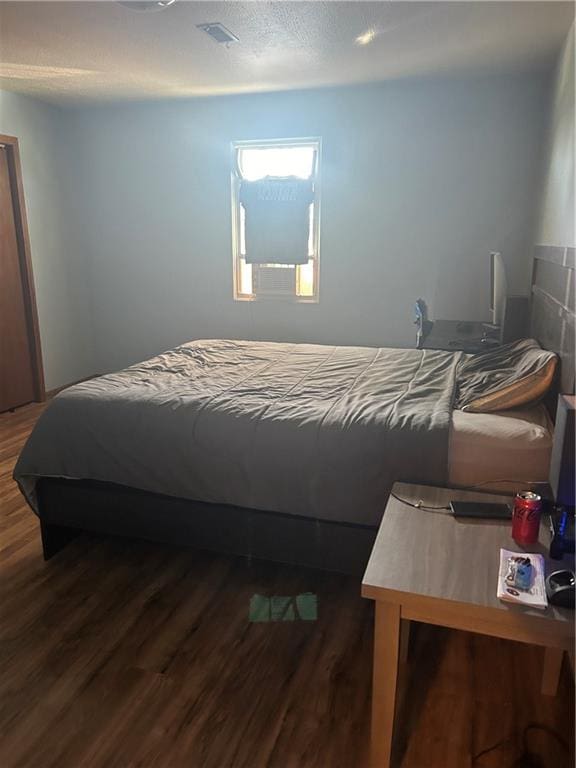 bedroom featuring dark hardwood / wood-style flooring