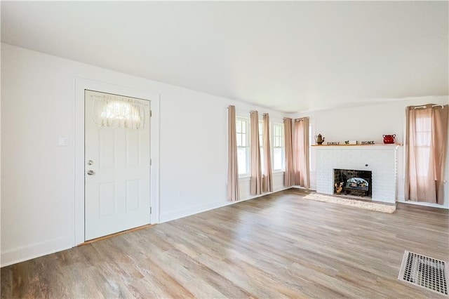 unfurnished living room with light hardwood / wood-style floors and a fireplace