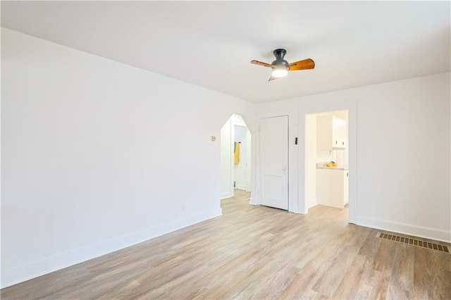 spare room featuring light wood-type flooring and ceiling fan