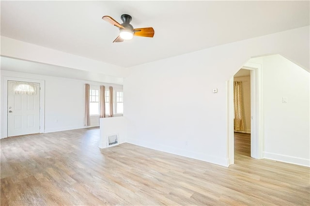 empty room with ceiling fan and light hardwood / wood-style floors