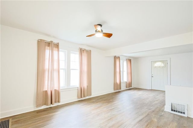 unfurnished room featuring light hardwood / wood-style flooring and ceiling fan