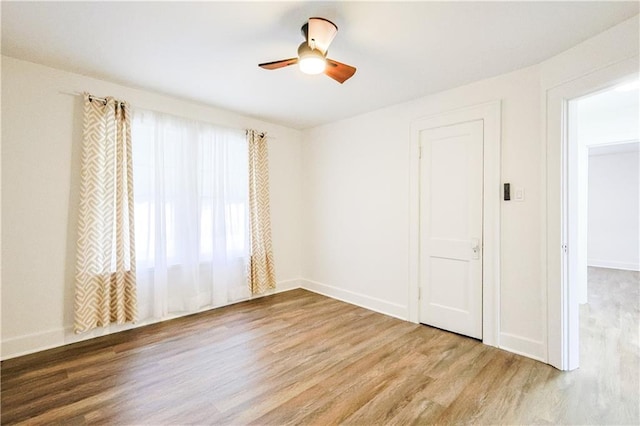 spare room featuring ceiling fan and wood-type flooring