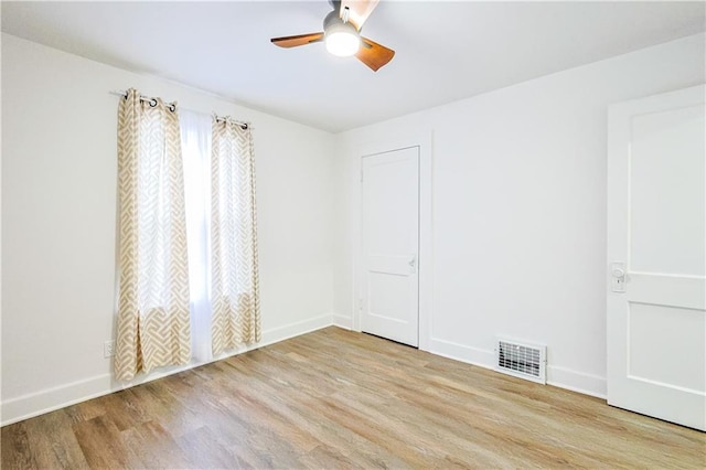 unfurnished room with light hardwood / wood-style flooring and ceiling fan