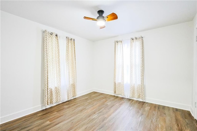 empty room featuring hardwood / wood-style floors and ceiling fan