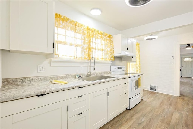 kitchen with light stone countertops, sink, white electric range oven, white cabinets, and light wood-type flooring