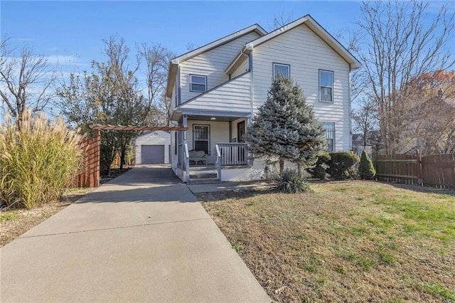 front facade featuring a porch, an outdoor structure, and a front yard