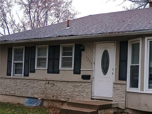6204 Fairlane Dr, Kansas City, MO 64134 - doorway to property featuring roof with shingles