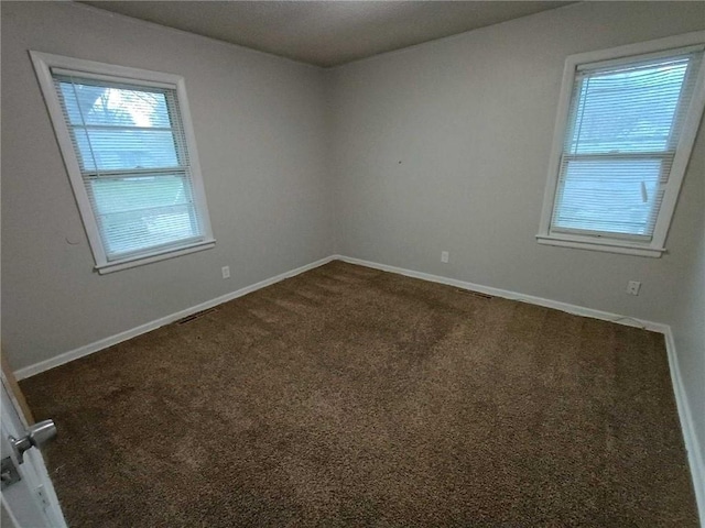 6204 Fairlane Dr, Kansas City, MO 64134 - empty room with dark carpet and baseboards