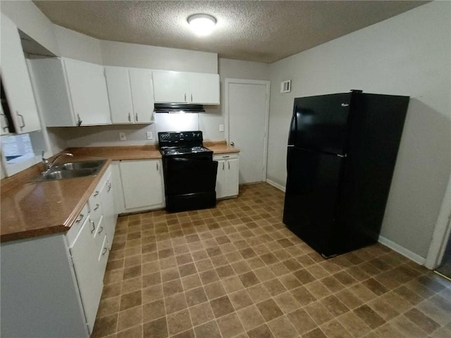 6204 Fairlane Dr, Kansas City, MO 64134 - kitchen featuring black appliances, a textured ceiling, under cabinet range hood, white cabinets, and tile patterned floors