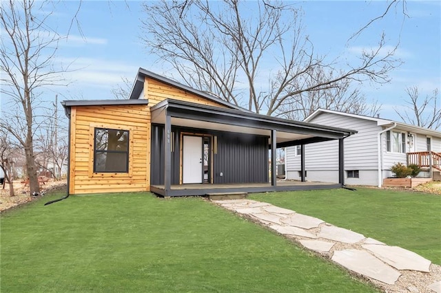 rear view of property with a porch and a yard