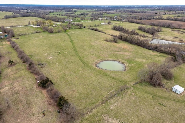 aerial view with a rural view and a water view