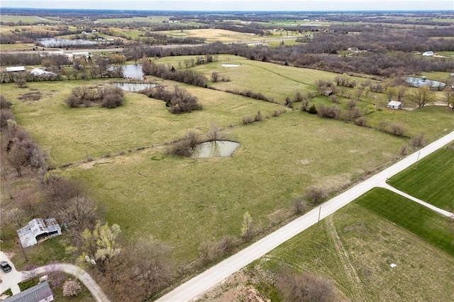 birds eye view of property with a water view and a rural view