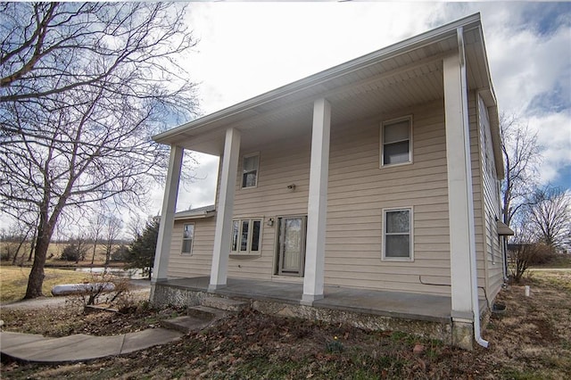 back of property with covered porch