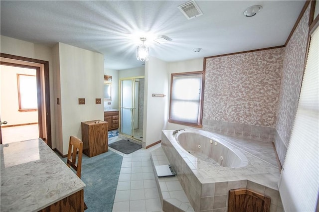 bathroom featuring vanity, a healthy amount of sunlight, and plus walk in shower