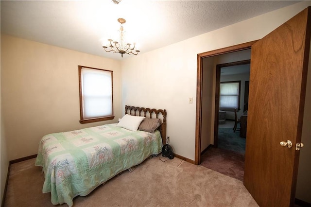 carpeted bedroom with an inviting chandelier