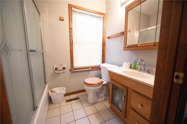 bathroom with toilet, vanity, and tile patterned floors