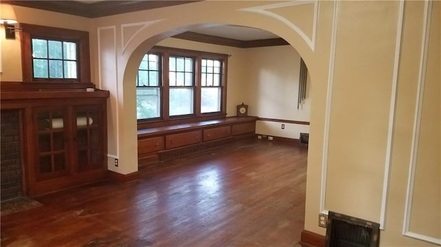 interior space featuring dark hardwood / wood-style flooring and ornamental molding