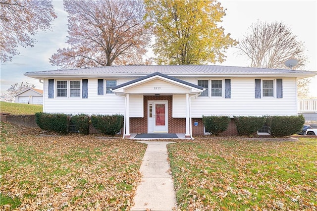 raised ranch featuring a front lawn