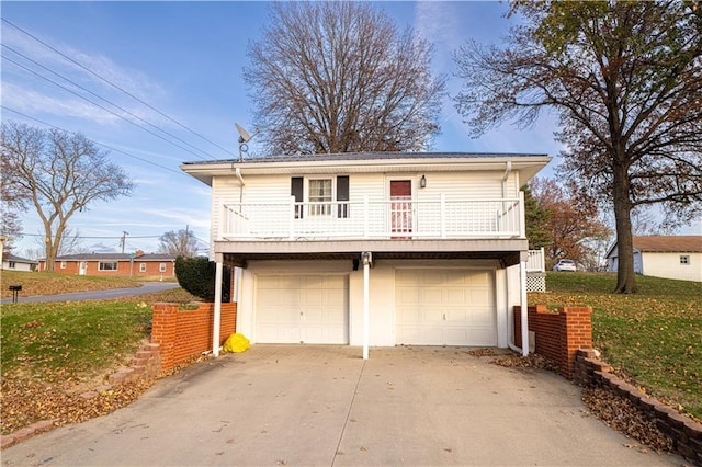 view of front of home with a garage, a balcony, and a front lawn