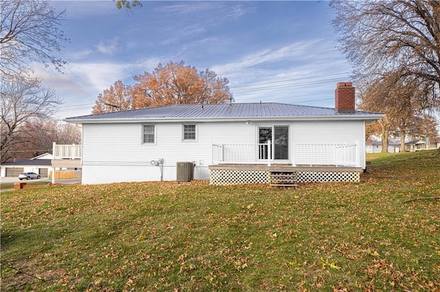 rear view of property with central AC, a yard, and a deck