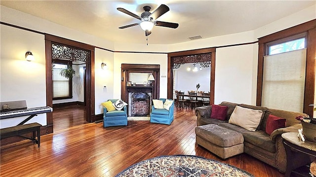 living room featuring hardwood / wood-style flooring and ceiling fan