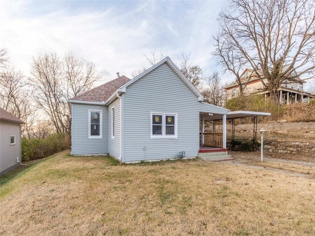 rear view of property featuring a yard