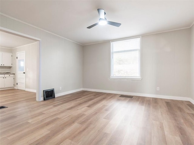 unfurnished room featuring crown molding, ceiling fan, and light hardwood / wood-style floors