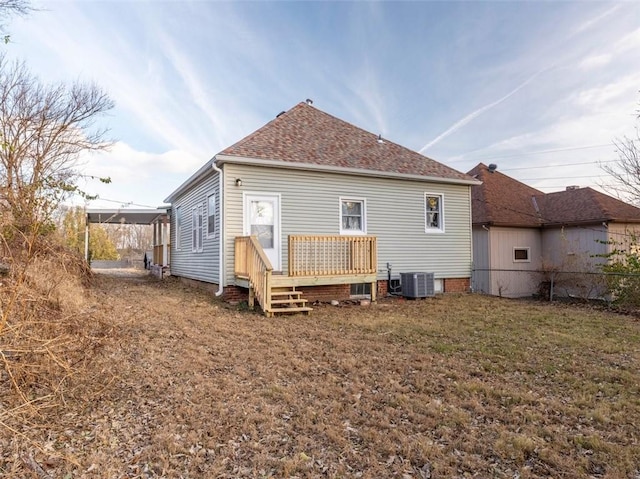 rear view of property featuring central AC, a yard, and a wooden deck