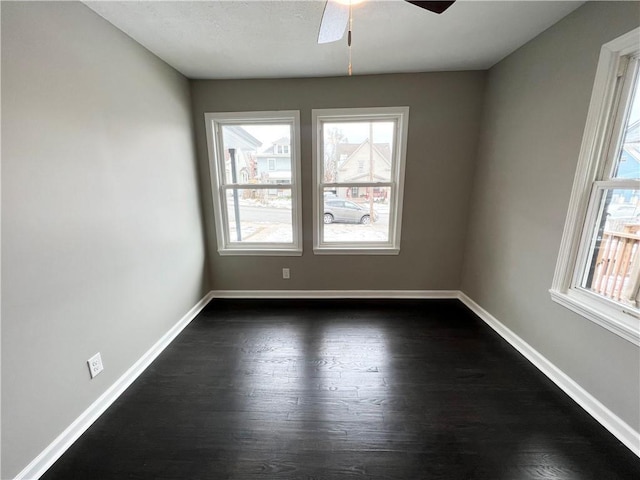 unfurnished room with dark hardwood / wood-style floors and ceiling fan