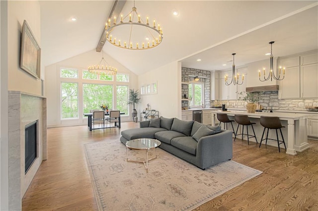 2150 NW Scenic View Dr, Riverside, MO 64150 - living area with a chandelier, light wood-style floors, plenty of natural light, beam ceiling, and high vaulted ceiling