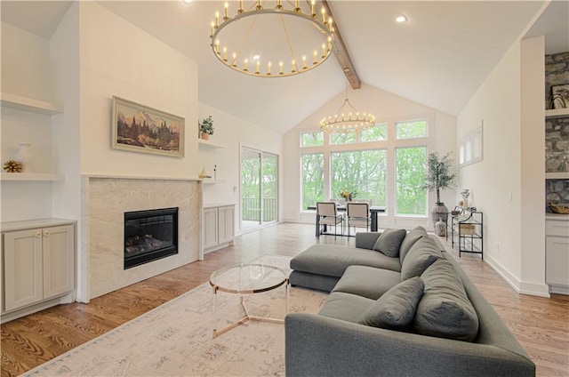 2150 NW Scenic View Dr, Riverside, MO 64150 - living room with a chandelier, light wood-style flooring, beam ceiling, high vaulted ceiling, and a fireplace