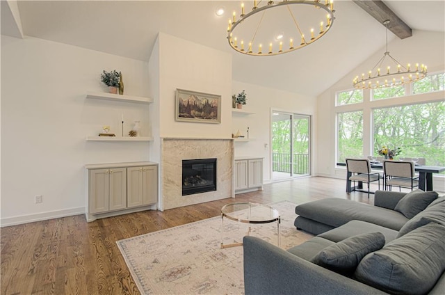 2150 NW Scenic View Dr, Riverside, MO 64150 - living room with a chandelier, beamed ceiling, healthy amount of natural light, wood finished floors, and high vaulted ceiling