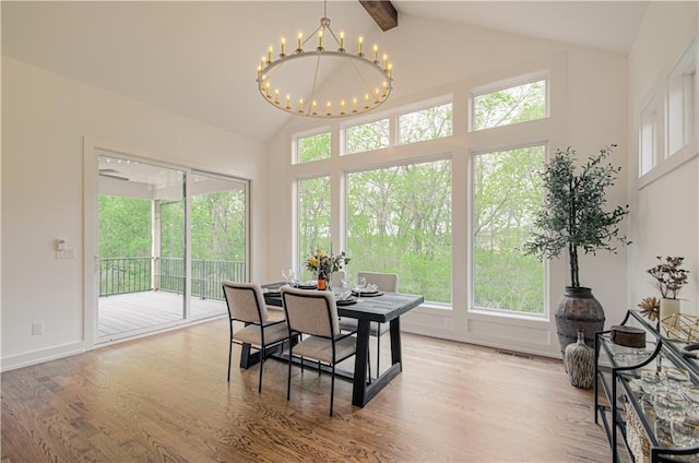 2150 NW Scenic View Dr, Riverside, MO 64150 - dining room with a chandelier, beam ceiling, wood finished floors, and high vaulted ceiling