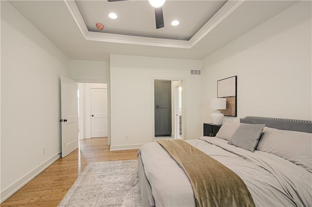 2150 NW Scenic View Dr, Riverside, MO 64150 - bedroom featuring a raised ceiling, light wood-style flooring, recessed lighting, a ceiling fan, and connected bathroom