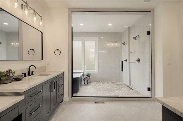 2150 NW Scenic View Dr, Riverside, MO 64150 - bathroom with vanity, a shower stall, a freestanding bath, tile patterned floors, and recessed lighting