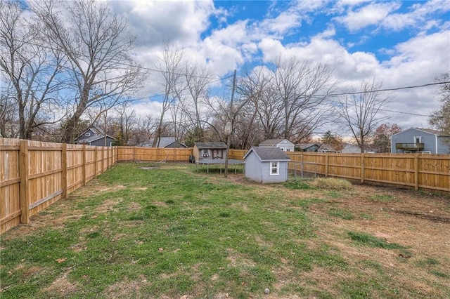 view of yard featuring a trampoline and a storage shed