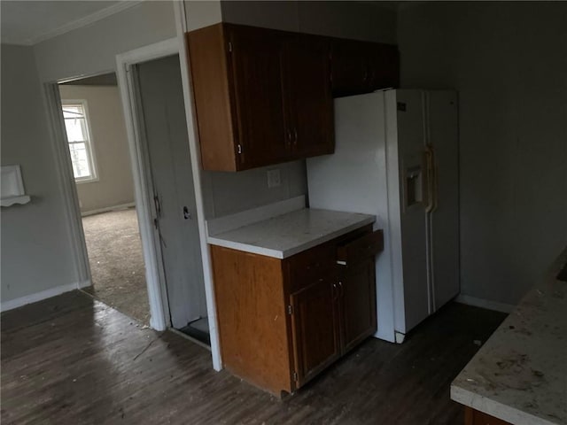 kitchen featuring dark hardwood / wood-style floors and white fridge with ice dispenser