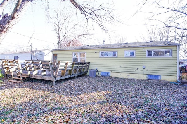 back of house featuring central AC unit and a deck