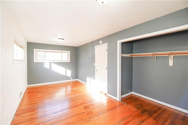 unfurnished bedroom with hardwood / wood-style flooring and a closet