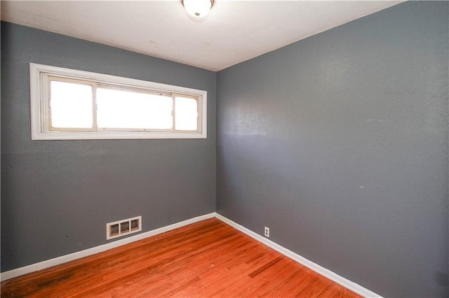 empty room featuring wood-type flooring