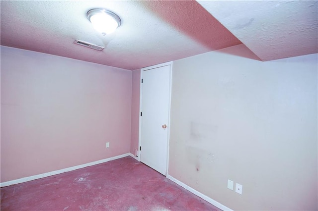 interior space featuring carpet flooring and a textured ceiling