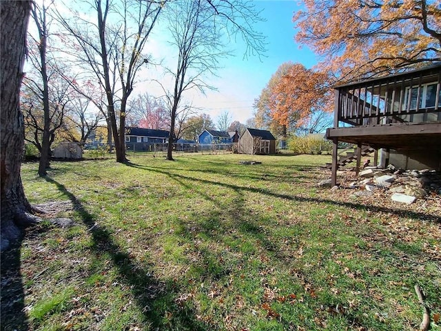 view of yard featuring a storage shed and a deck