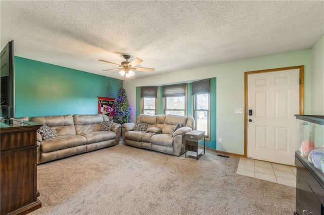 carpeted living room with ceiling fan and a textured ceiling