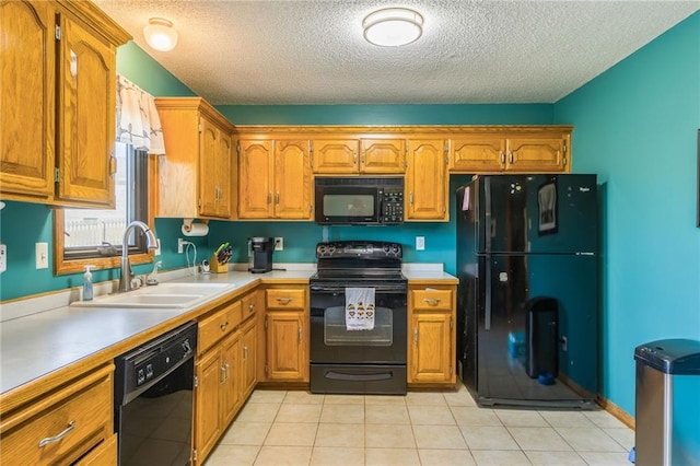 kitchen with black appliances, light tile patterned flooring, sink, and a textured ceiling