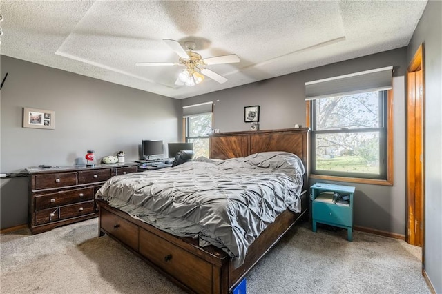 bedroom with ceiling fan, carpet floors, and a textured ceiling