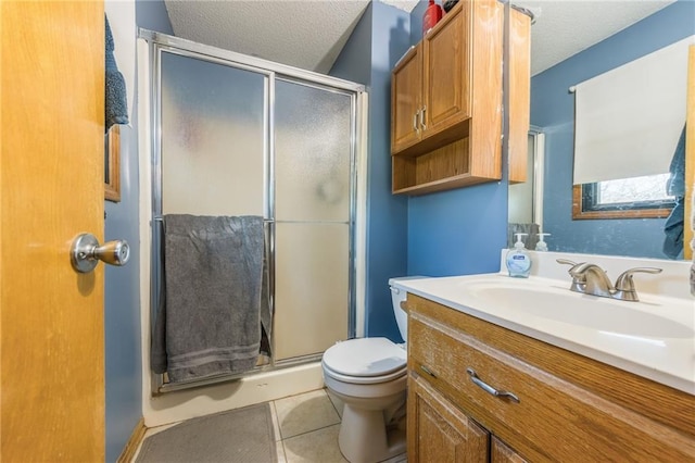 bathroom with tile patterned floors, an enclosed shower, a textured ceiling, toilet, and vanity