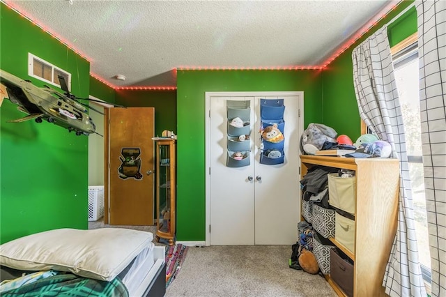 bedroom featuring carpet and a textured ceiling